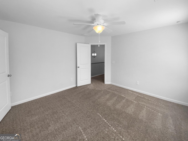 unfurnished bedroom featuring ceiling fan, carpet flooring, and baseboards