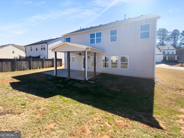 back of property with a patio area, a yard, fence, and ceiling fan