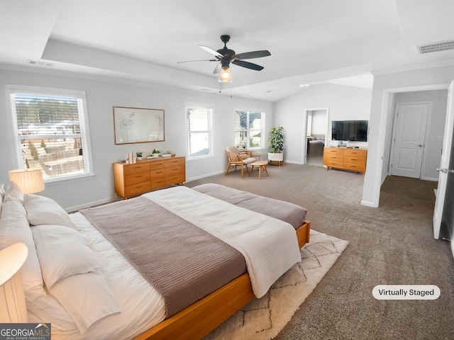 bedroom with carpet floors, a raised ceiling, visible vents, and baseboards