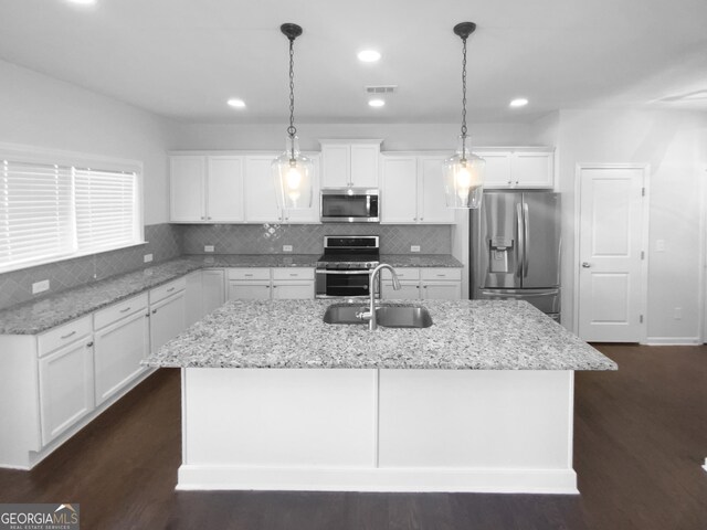 362 Reserve Overlook, Canton, GA 30115 - kitchen with stainless steel appliances, a kitchen island with sink, white cabinets, tasteful backsplash, and recessed lighting