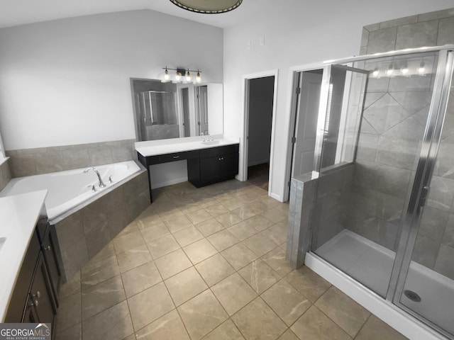 full bath featuring lofted ceiling, a stall shower, a bath, and vanity