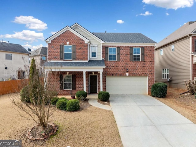 traditional-style house with a garage, concrete driveway, brick siding, and covered porch