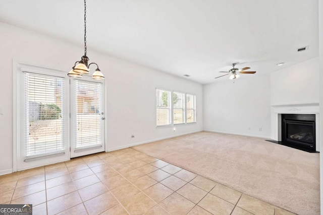 unfurnished living room with a fireplace with flush hearth, light colored carpet, visible vents, and light tile patterned floors