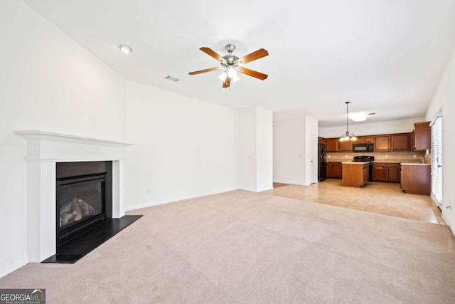 unfurnished living room featuring light tile patterned floors, light carpet, a fireplace with flush hearth, visible vents, and a ceiling fan