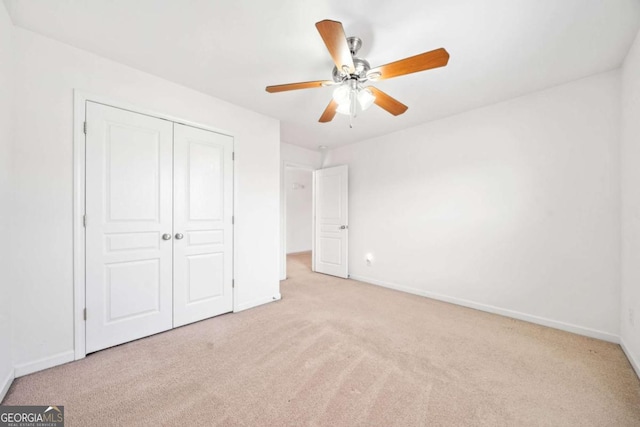 unfurnished bedroom featuring carpet floors, a closet, and baseboards