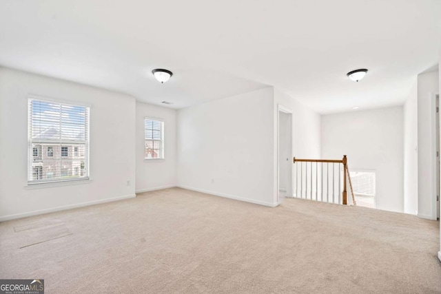 carpeted empty room with baseboards