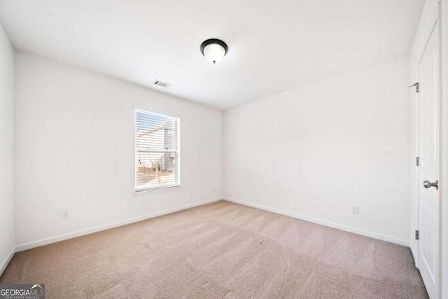 unfurnished room with baseboards, visible vents, and carpet flooring