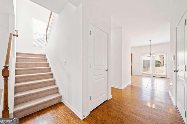 stairs featuring baseboards and wood finished floors