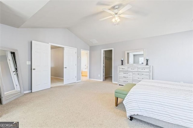 bedroom with a spacious closet, baseboards, lofted ceiling, light carpet, and a closet