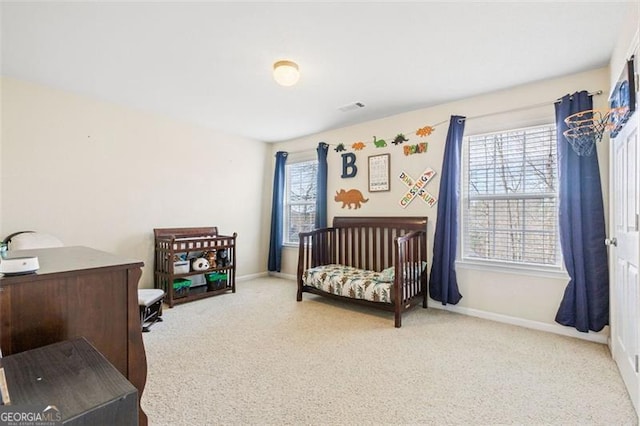 bedroom featuring visible vents, baseboards, and carpet