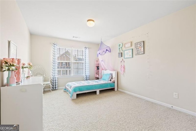 carpeted bedroom with visible vents and baseboards