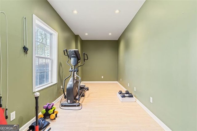 workout area featuring recessed lighting, baseboards, and wood finished floors