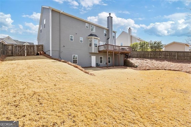 back of house featuring a deck and a fenced backyard