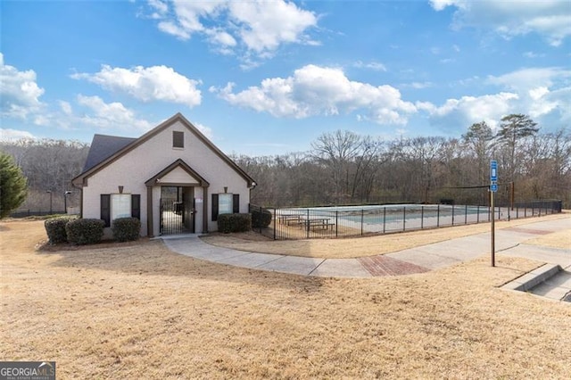 view of home's community with a gate and fence