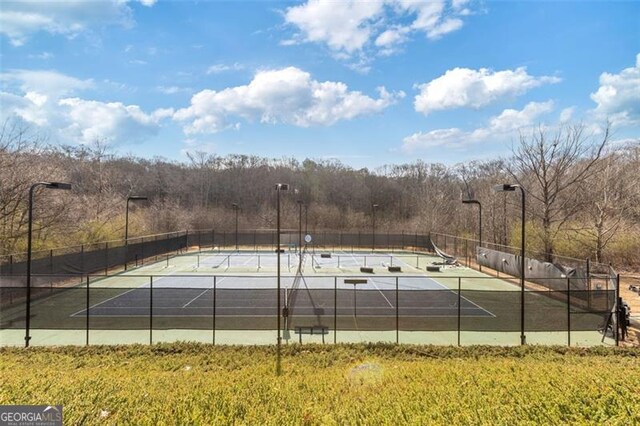 view of tennis court featuring fence