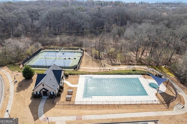 birds eye view of property with a view of trees