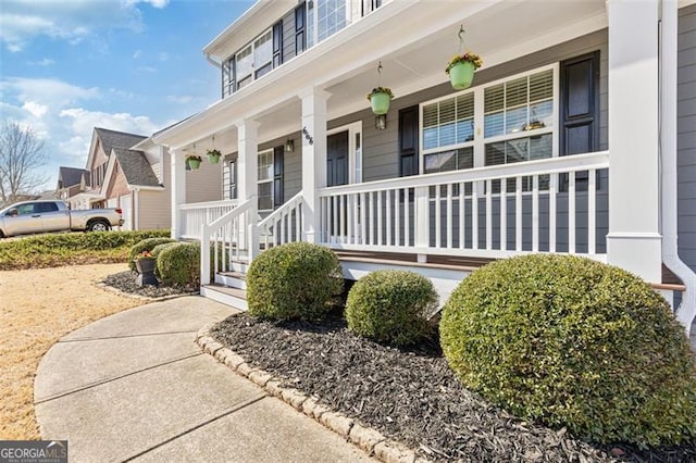 view of exterior entry featuring a porch