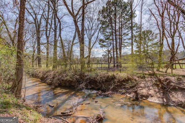 view of landscape featuring a forest view