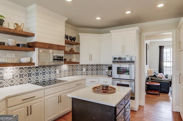 kitchen featuring double oven, black electric cooktop, open shelves, and light countertops