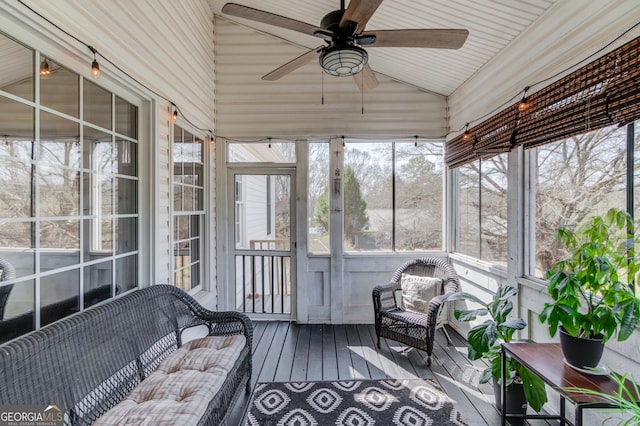 sunroom with lofted ceiling and ceiling fan