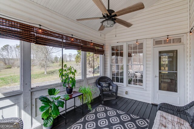 sunroom with lofted ceiling and ceiling fan