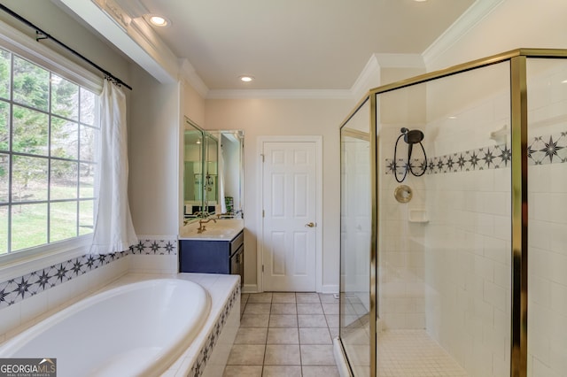 bathroom with a stall shower, a garden tub, crown molding, and tile patterned floors