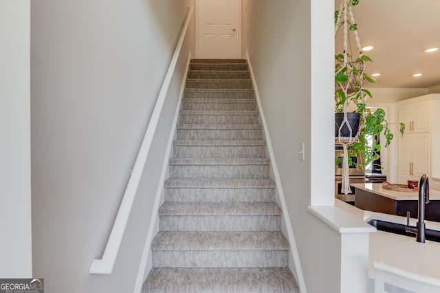 staircase featuring ornamental molding, recessed lighting, and baseboards