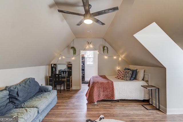 bedroom with vaulted ceiling, ceiling fan, wood finished floors, and baseboards