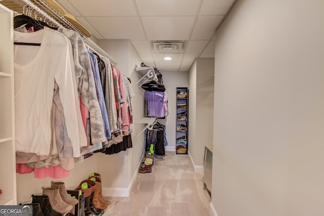 spacious closet featuring carpet floors, visible vents, and a paneled ceiling