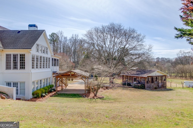 view of yard featuring a sunroom