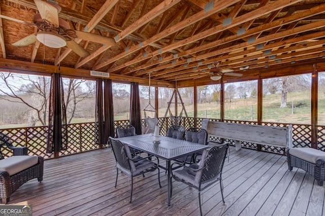 unfurnished sunroom with ceiling fan