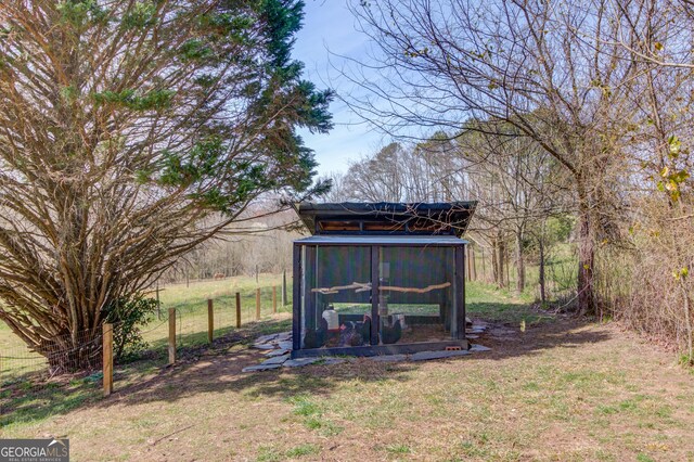 view of yard featuring an outdoor structure and exterior structure