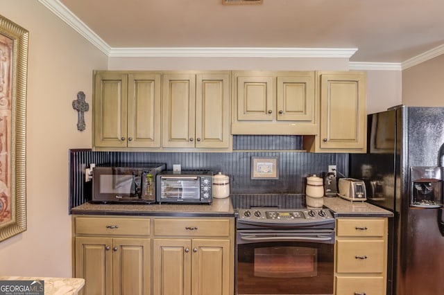 kitchen with ornamental molding, under cabinet range hood, electric range, and black fridge