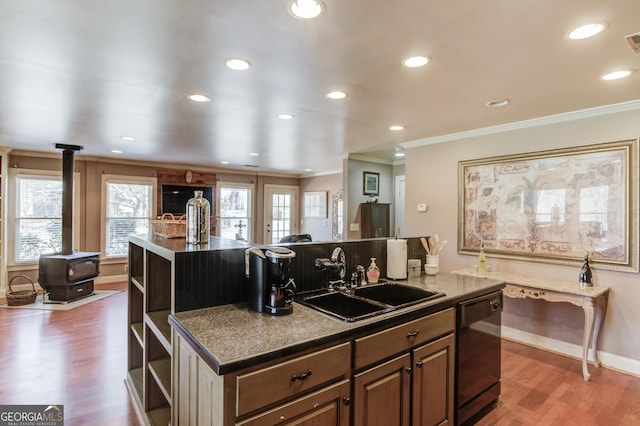 kitchen with dishwasher, a sink, a center island with sink, and a healthy amount of sunlight