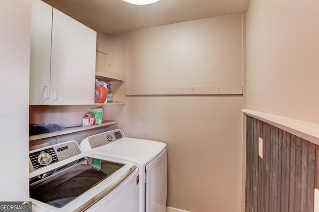 clothes washing area with cabinet space and washing machine and dryer