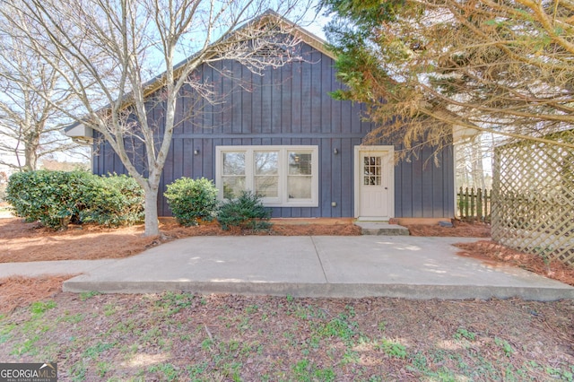 view of front facade featuring fence and board and batten siding