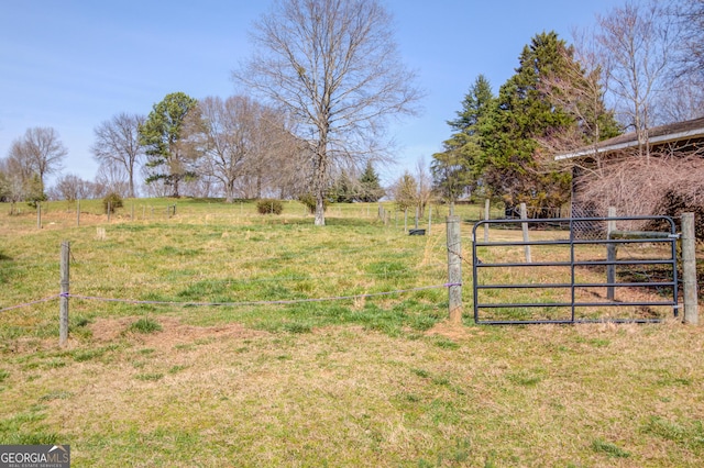 view of yard featuring a gate and a rural view