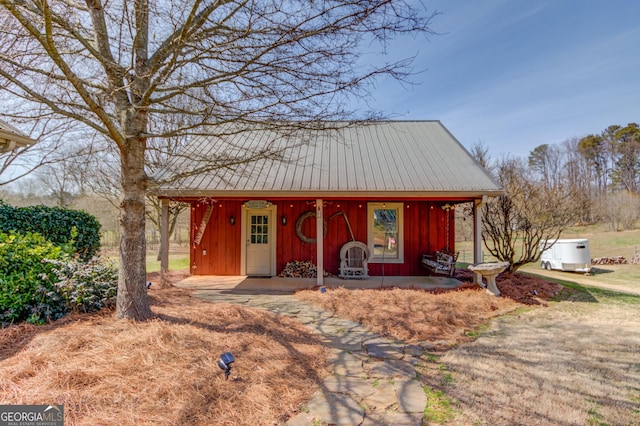 view of front of house featuring metal roof and a porch