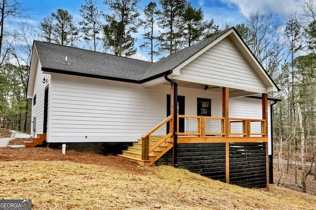 view of front facade with a porch and roof with shingles