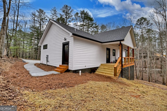 view of property exterior with roof with shingles