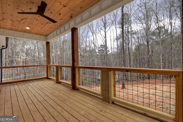 wooden deck featuring ceiling fan