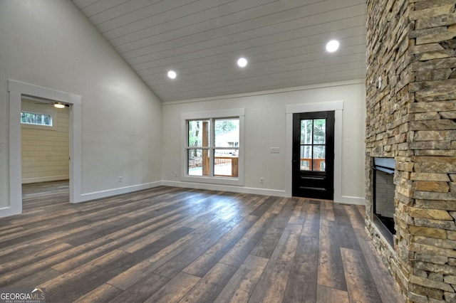 interior space with baseboards, dark wood-style flooring, a fireplace, high vaulted ceiling, and recessed lighting