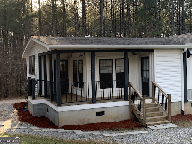 view of front of property with a shingled roof, crawl space, and covered porch