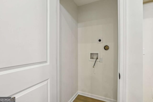 interior space featuring washer hookup, dark wood-style flooring, electric dryer hookup, laundry area, and baseboards