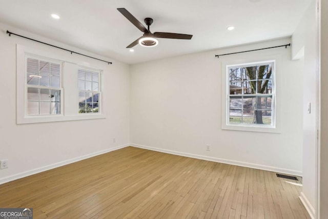 empty room featuring baseboards, visible vents, a ceiling fan, light wood-type flooring, and recessed lighting