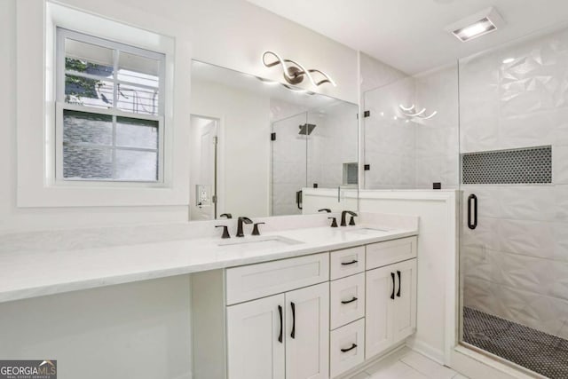 full bathroom featuring a sink, a shower stall, and double vanity