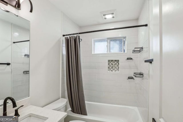 bathroom with toilet, shower / bath combo, and vanity