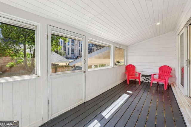 sunroom / solarium featuring lofted ceiling and a healthy amount of sunlight