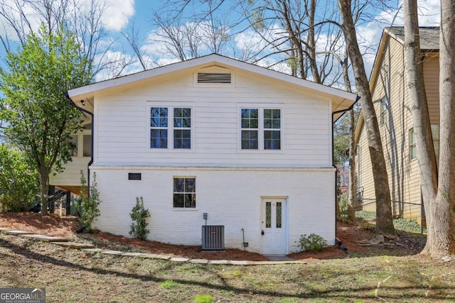 view of side of property with brick siding and central AC unit