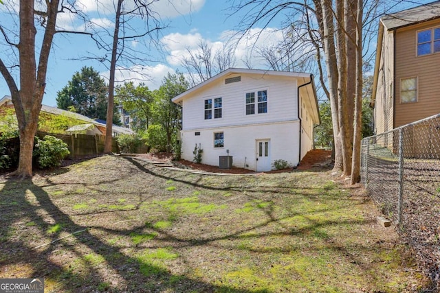 back of property with central AC and fence